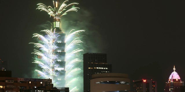 Fireworks shoot out from the Taipei 101 building during the New Year's celebrations in Taipei, Taiwan, Friday, Jan. 1, 2021. (AP Photo/Chiang Ying-ying)