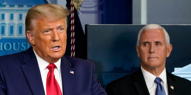 FILE - In this Nov. 24, 2020, file photo President Donald Trump speaks in the press briefing room as Vice President Mike Pence listens in Washington. (Associated Press)