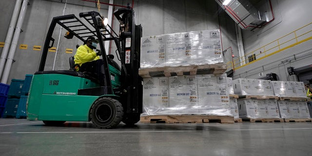 Boxes containing the Pfizer-BioNTech COVID-19 vaccine are moved to the loading dock for shipping at the Pfizer Global Supply Kalamazoo manufacturing plant in Portage, Mich., Sunday, Dec. 13, 2020.