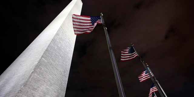 American flags fly around the Washington Monument Friday, Dec. 18, 2020, in Washington. The Trump administration has closed the Washington Monument because of a recent visit by Interior Secretary David Bernhardt, who tested positive this week for the coronavirus. Interior spokesman Nicholas Goodwin says a couple monument workers were quarantining as a result of Bernhardt's visit, forcing a staffing shortage and the monument's closure. (AP Photo/Manuel Balce Ceneta)
