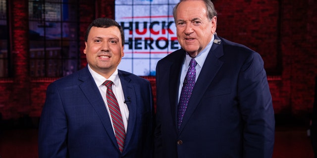 Xavier DeGroat, a Michigan student, with former Gov. Mike Huckabee. DeGroat was honored as a 