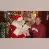 The first year we took our grandchild Anessa to see Santa, we waited in line for a long time at the annual Santa's Village to get that perfect picture. Someone suggested my husband hold her with her back to Santa then walk up and quickly place her down to sit on Santa's lap and run... the perfect Santa picture before she had a chance to cry! Well, obviously... she was quick on the stick because we got the perfect Santa picture, but a lot different than we thought! Her death grip on my husband was tight and she was not letting go! She is almost 12 now and we still bring out this picture to remind her of her first visit with Santa! So adorable. Hope you enjoy and get a big smile remembering some of your own experiences! I took the picture. Barbara Glenn