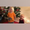 Grabs children standing by the tree after helping put all the Christmas ornaments