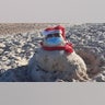 On the beach in St George Island, Florida we found jolly St. Nick. Wearing his mask too!