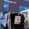 A FedEx driver delivers a box containing the Pfizer-BioNTech COVID-19 vaccine to Rhode Island Hospital in Providence, R.I., Monday, Dec. 14, 2020.