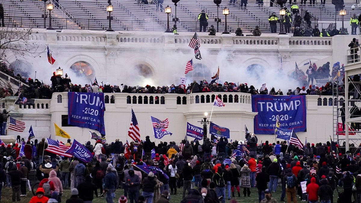 In this Wednesday, Jan. 6, 2021, file photo, violent protesters, loyal to President Donald Trump, storm the Capitol, in Washington. A Massachusetts teenager publicly called out her relatives after recognizing them as possible rioters during last week’s riot in Washington D.C.. (AP Photo/John Minchillo, File)