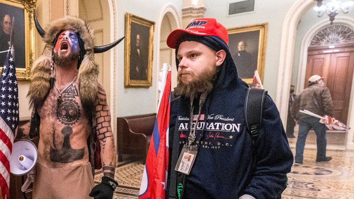 Supporters of President Donald Trump are confronted by Capitol Police officers outside the Senate Chamber inside the Capitol, Wednesday, Jan. 6, 2021 in Washington. (AP Photo/Manuel Balce Ceneta)