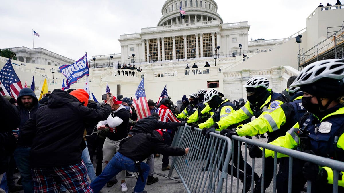 Trump supporters try to break through a police barrier at the Capitol in Washington on Jan. 6