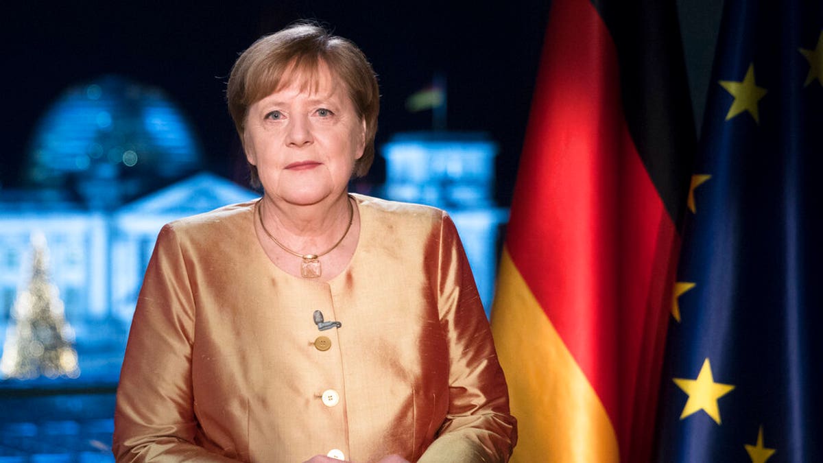 German Chancellor Angela Merkel poses for photographs after the television recording of her annual New Year's speech at the chancellery in Berlin, Germany. 