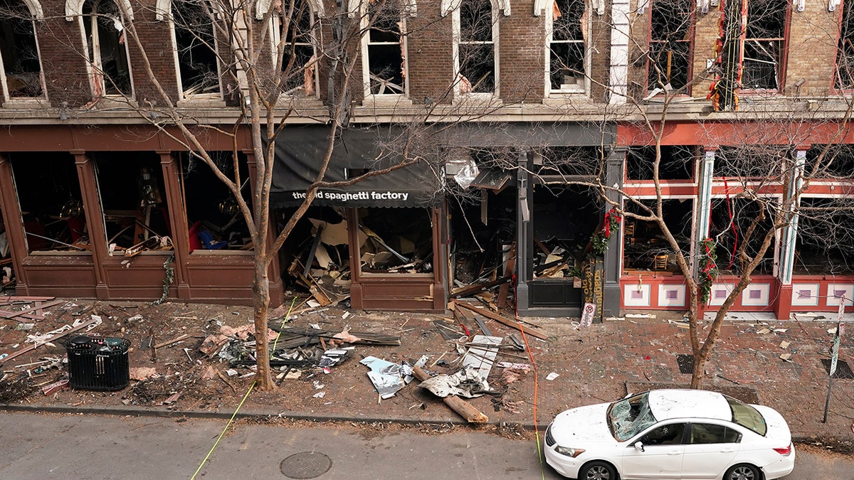 In this Dec. 29, 2020 file photo, debris remains on the sidewalk in front of buildings damaged in a Christmas Day explosion in Nashville, Tenn. (AP Photo/Mark Humphrey, File)