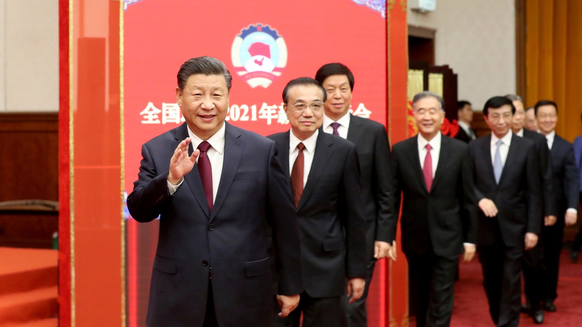 In this photo released by China's Xinhua News Agency, Chinese President Xi Jinping, left, Premier Li Keqiang, second from left, and other top leaders attend a New Year gathering hosted by the Chinese People's Political Consultative Conference (CPPCC) in Beijing, Thursday, Dec. 31, 2020. (Yao Dawei/Xinhua via AP)