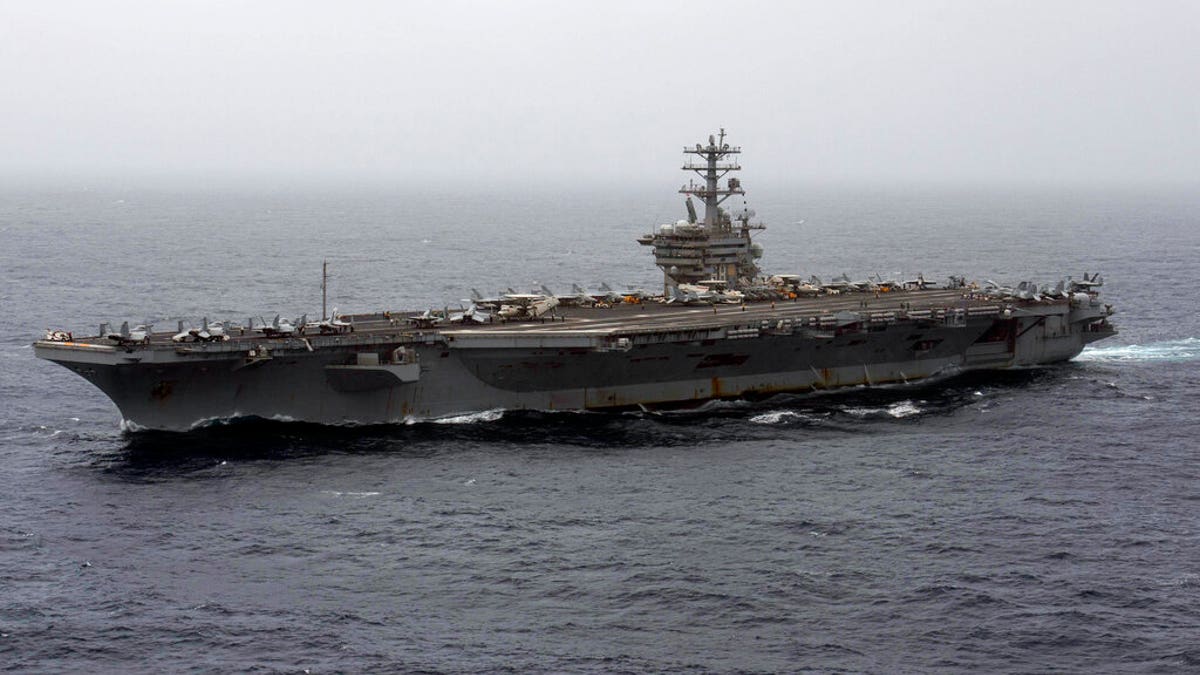 FILE - In this Sept. 7, 2020, file photo released by the U.S. Navy, the aircraft carrier USS Nimitz transits the Arabian Sea. The Pentagon announced Thursday, Dec. 31, 2020, that the USS Nimitz, the only Navy aircraft carrier operating in the Middle East, will return home to the U.S. West Coast.