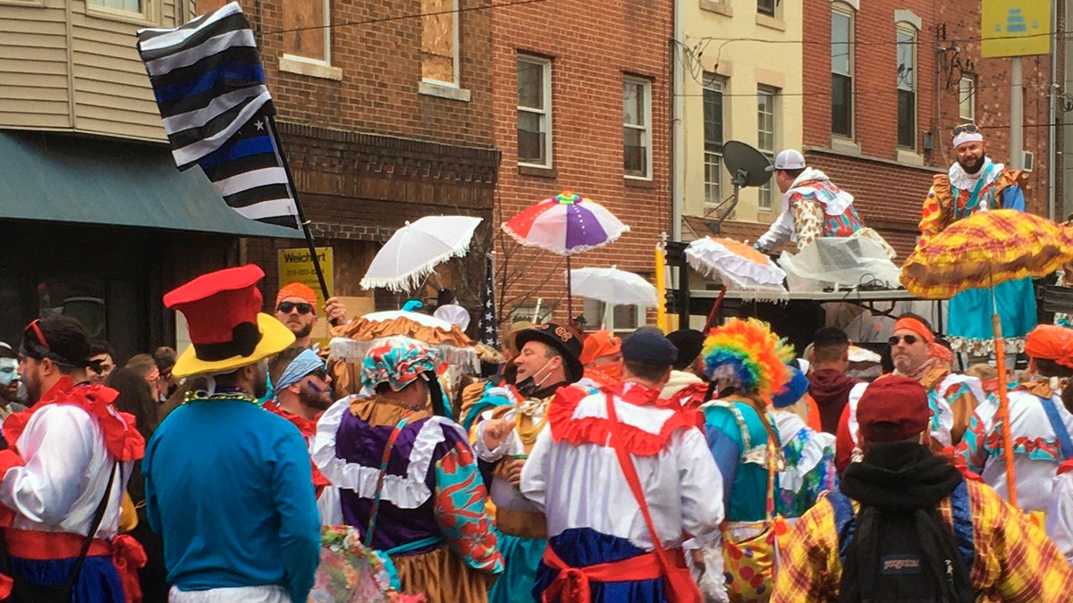 Costumed participants take to the streets of their south Philadelphia stomping grounds for a New Year’s celebration of Mummers tradition despite official cancellation of the annual event and a ban on large gatherings due to the coronavirus pandemic, Friday, Jan. 1, 2021 in Philadelphia. (AP Photo/Ron Todt)