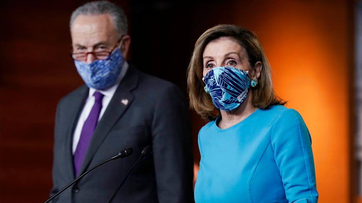 FILE - In this Thursday, Nov. 12, 2020 file photo, Speaker of the House Nancy Pelosi, D-Calif., and Senate Minority Leader Chuck Schumer, D-N.Y., meet with reporters on Capitol Hill in Washington. (AP Photo/J. Scott Applewhite, File)