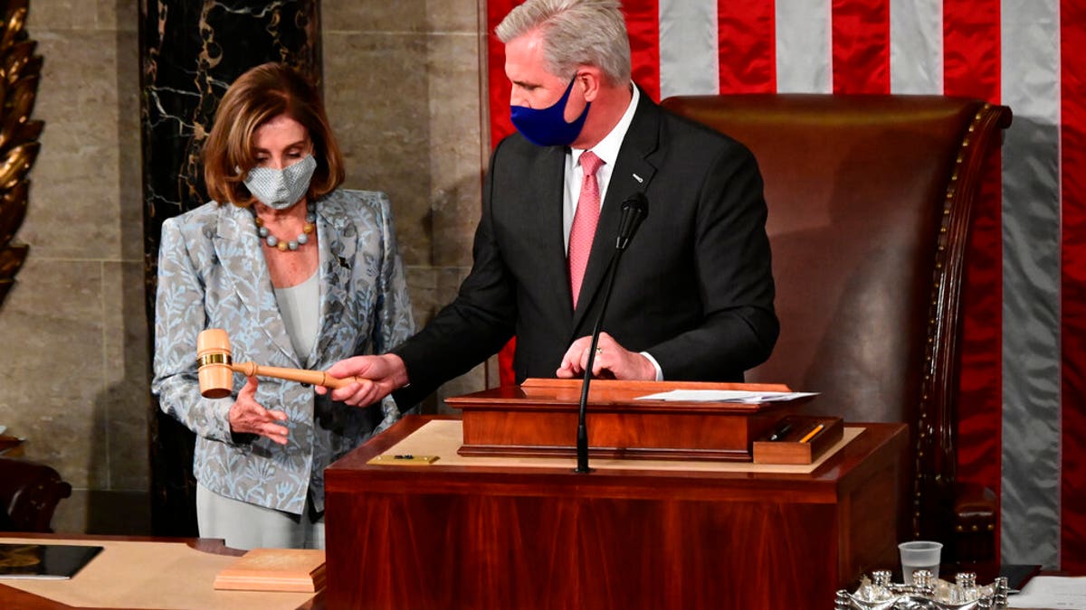 Speaker of the House Nancy Pelosi is handed the Speaker's gavel by House Minority Leader Kevin McCarthy, R-Calif., on the opening day of the 117th Congress on Capitol Hill in Washington, Sunday, Jan. 3, 2021.