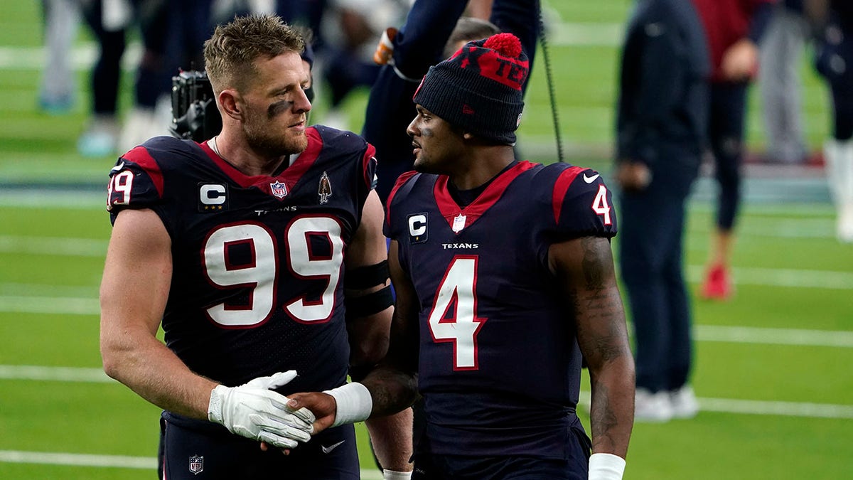 Houston Texans defensive end J.J. Watt (99) and quarterback Deshaun Watson (4) walk off the field after an NFL football game against the Tennessee Titans Sunday, Jan. 3, 2021, in Houston. The Titans won 41-38. (AP Photo/Eric Christian Smith)