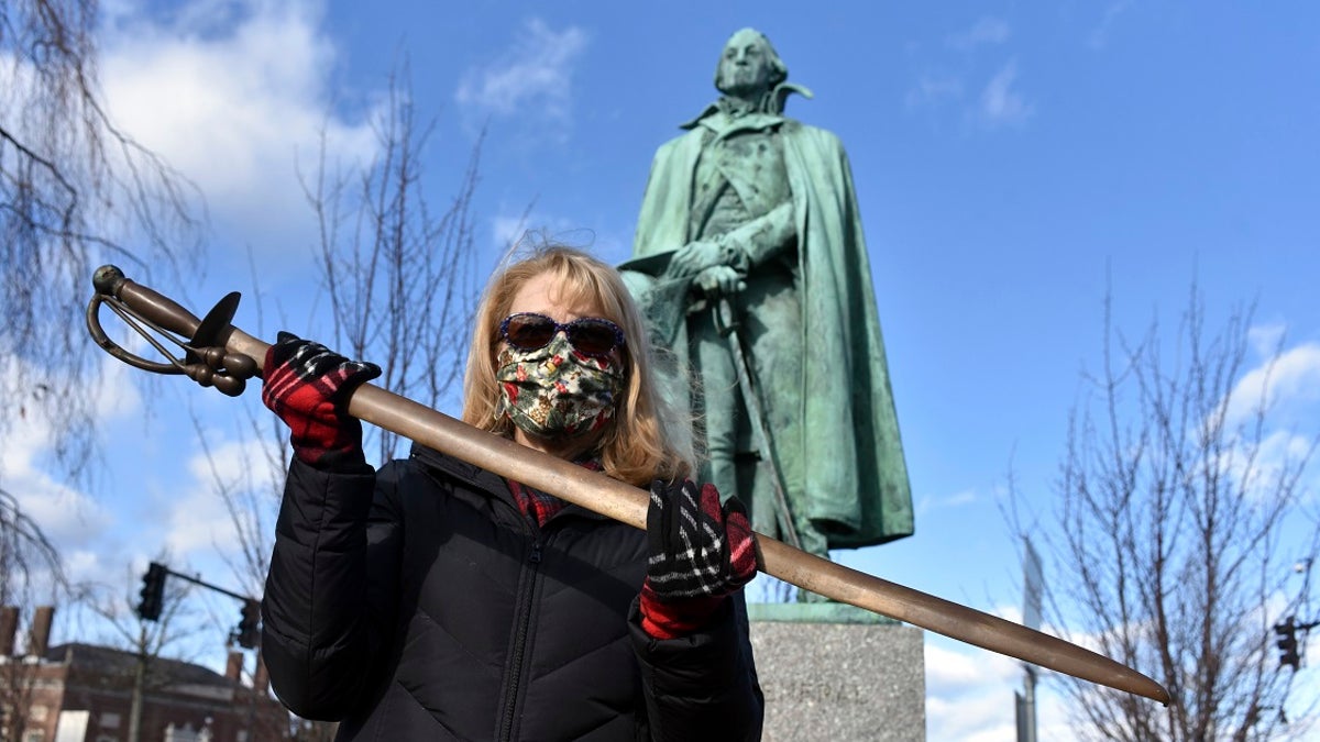 Cindy Gaylord, chairwoman of the Westfield Historical Commission, holds the original sword from the statue of Gen. William Shepard that stands near the town green in the center of Westfield, Mass. A veteran returned the sword he stole from the statue 40 years ago, telling Gaylord that he regretted taking it. (Don Treeger/The Republican via AP)