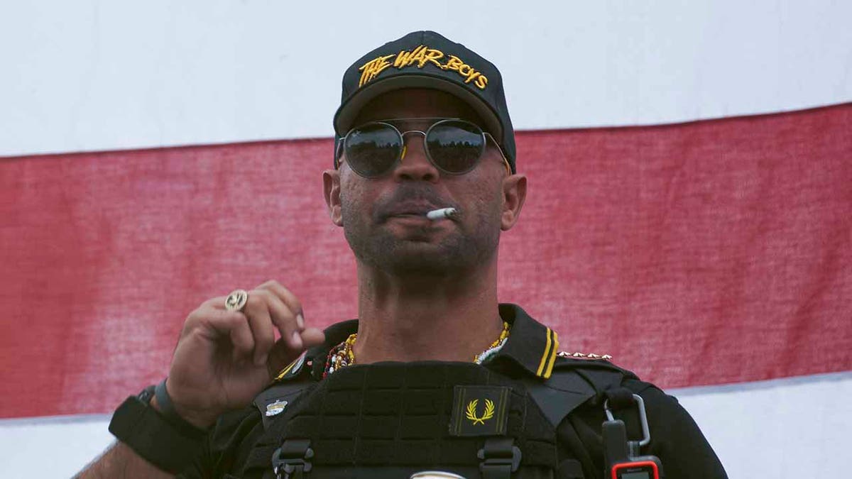 In this Sept. 26, 2020, file photo, Proud Boys leader Henry "Enrique" Tarrio wears a hat that says The War Boys during a rally in Portland, Ore. Police in the nation’s capital on Jan. 4, 2021, arrested the leader of the Proud Boys, who is accused of burning a Black Lives Matter banner that was torn down from a historic Black church in downtown Washington in December 2020. (AP Photo/Allison Dinner, File)