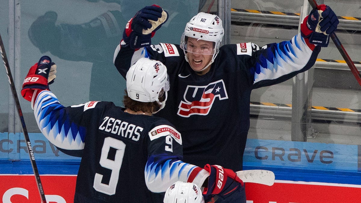 United States' Matthew Boldy (12) celebrates his goal against Finland with teammates Trevor Zegras (9) and Cole Caufield (13) during second-period IIHF World Junior Hockey Championship action in Edmonton, Alberta, Monday, Jan. 4, 2021. (Jason Franson/The Canadian Press via AP)