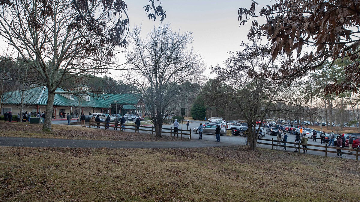 Voters wait in line to cast their ballots in Georgia's Senate runoff elections at a senior center, Tuesday, Jan. 5, 2021, in Acworth, Ga. (AP Photo/Branden Camp)