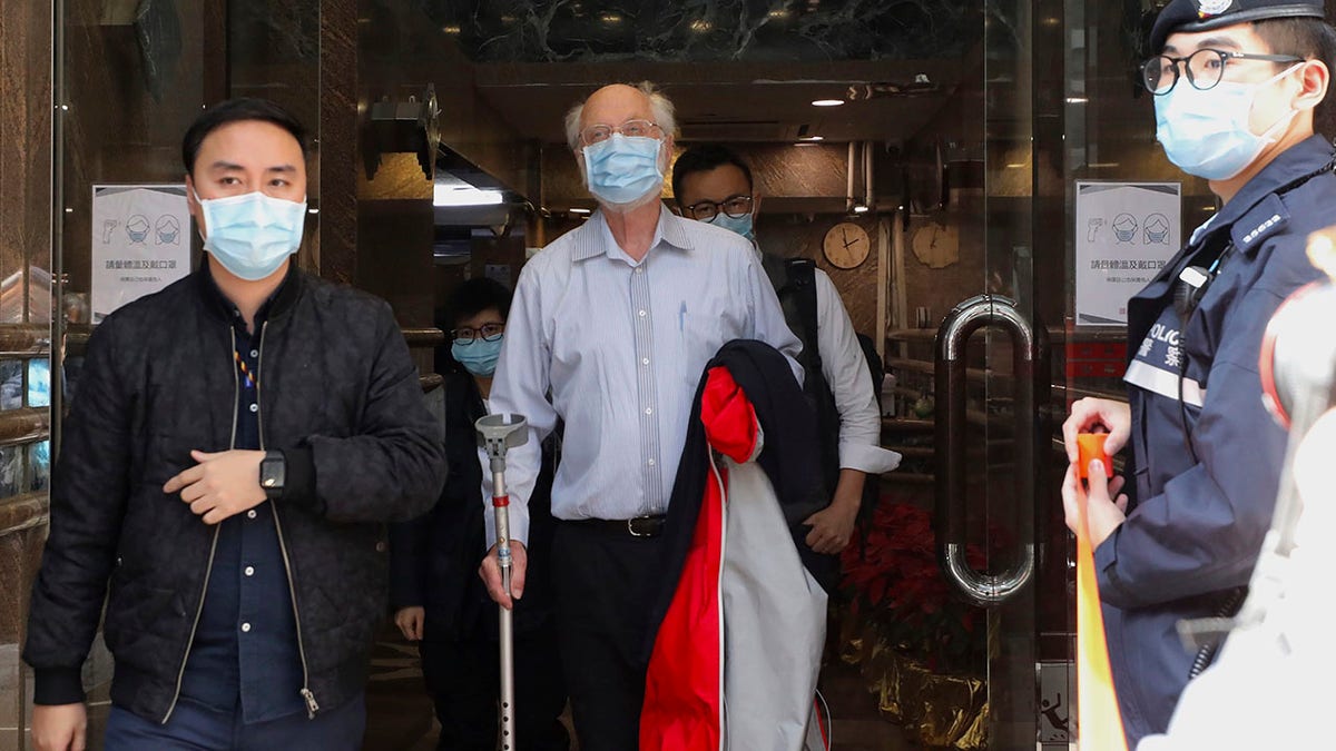 American human rights lawyer John Clancey, center, is arrested by police in Hong Kong Wednesday, Jan. 6, 2021. (Associated Press)