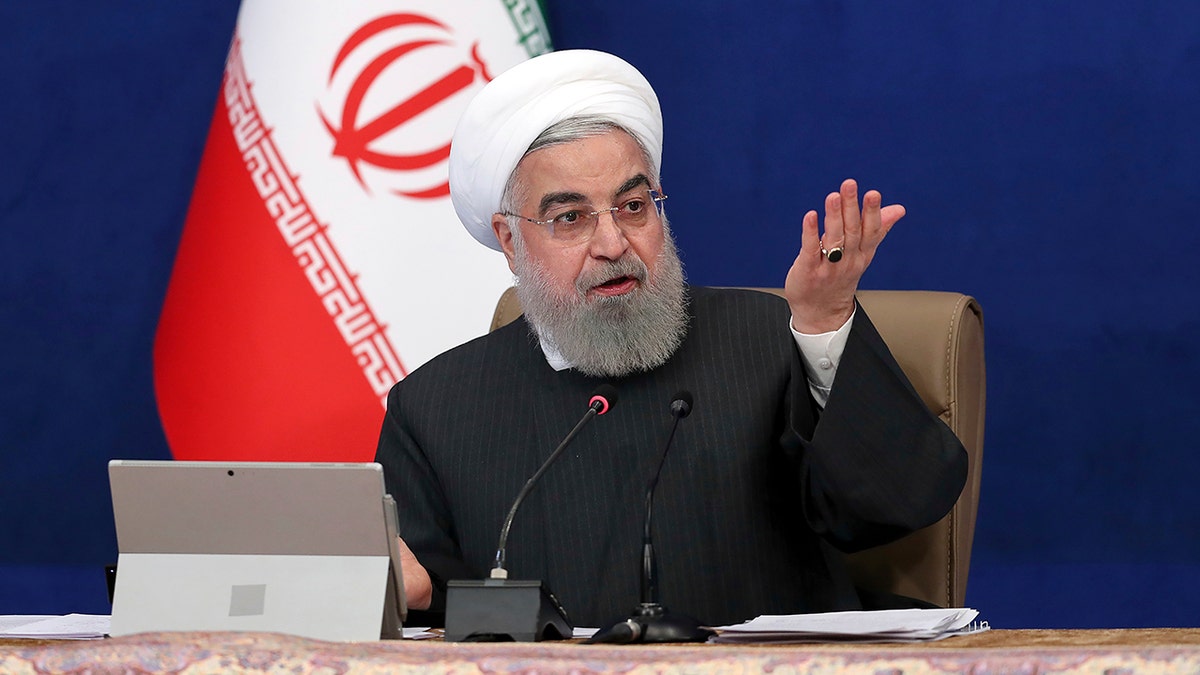 Iranian President Rouhani motions with hishand