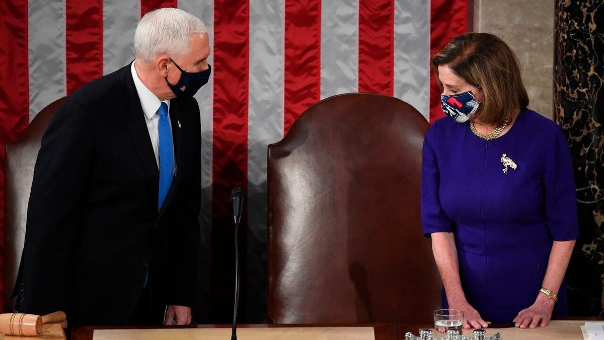 Speaker of the House Nancy Pelosi, D-Calif., and Vice President Mike Pence talk before a joint session of the House and Senate convenes to count the Electoral College votes cast in November's election, at the Capitol in Washington, Wednesday, Jan. 6, 2021. (Saul Loeb/Pool via AP)