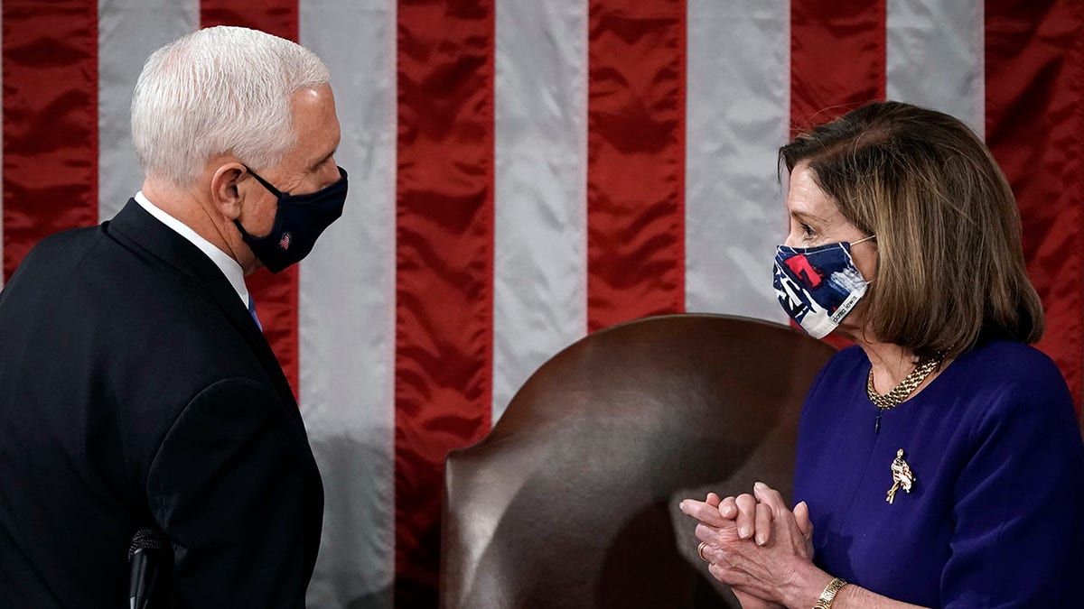 Speaker of the House Nancy Pelosi, D-Calif., and Vice President Mike Pence talk before a joint session of the House and Senate convenes to confirm the Electoral College votes cast in November's election, at the Capitol in Washington, Wednesday, Jan. 6, 2021. (Associated Press)