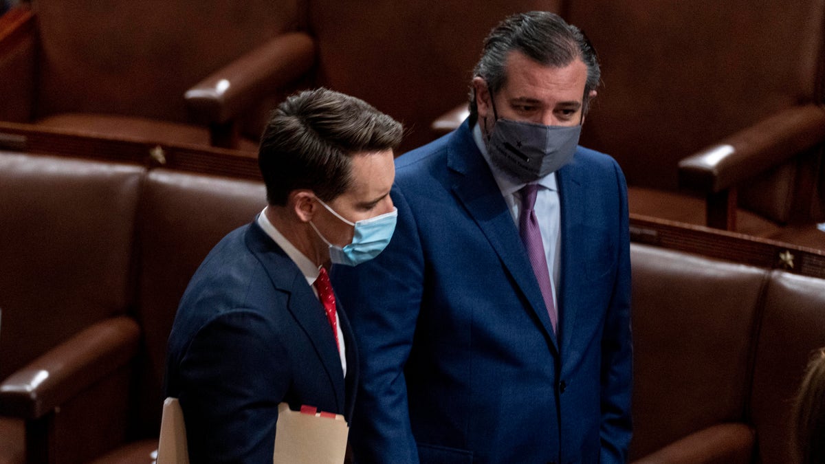 Sen. Josh Hawley, R-Mo., left, and Sen. Ted Cruz, R-Texas, right, speak after Republicans objected to certifying the Electoral College votes from Arizona, during a joint session of the House and Senate to confirm the electoral votes cast in November's election, at the Capitol, Wednesday, Jan 6, 2021. (AP Photo/Andrew Harnik)