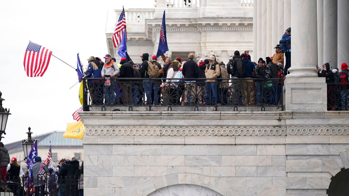 Trump supporters gather outside the Capitol, Wednesday, Jan. 6, 2021, in Washington. As Congress prepares to affirm President-elect Joe Biden's victory, thousands of people have gathered to show their support for President Trump and his claims of election fraud. (AP Photo/Manuel Balce Ceneta)