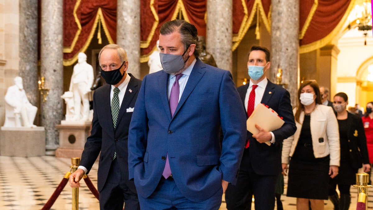 Sen. Ted Cruz, R-Texas, front, followed by Sen. Josh Hawley, R-Mo., walks from the House Chamber during a joint session to confirm the Electoral College votes on Wednesday, Jan. 6, 2021, in Washington. (AP Photo/Manuel Balce Ceneta)