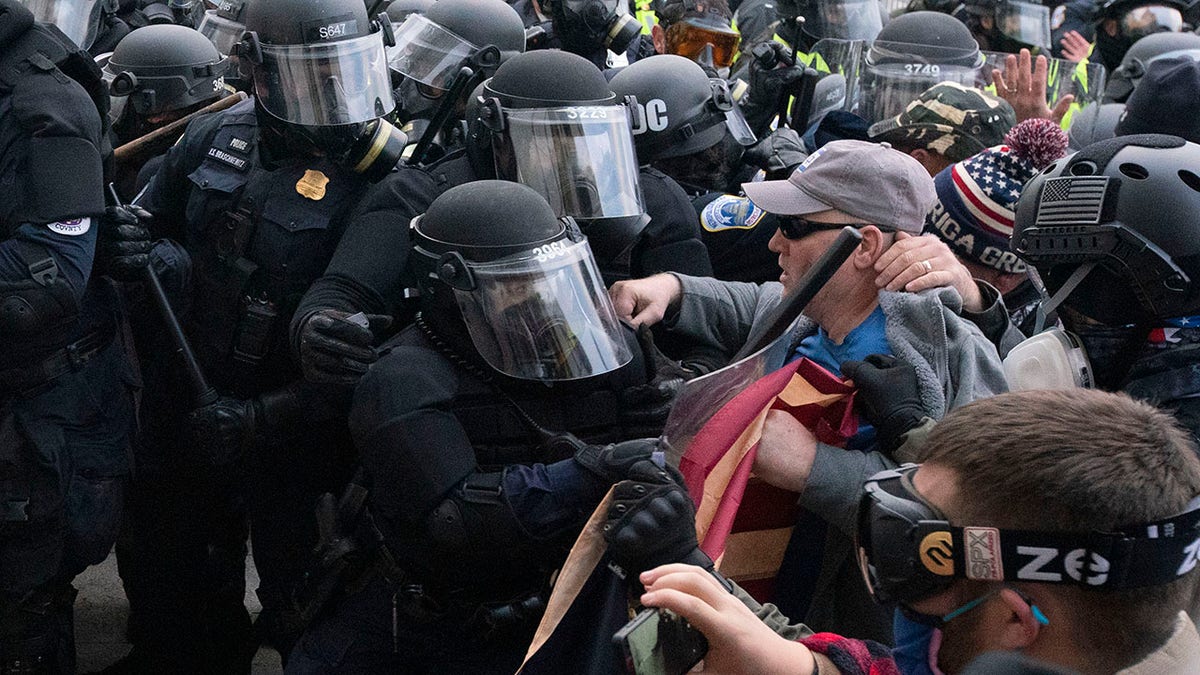 Capitol Police officers in riot gear push back as demonstrators try to break a door of the U.S. Capitol on Wednesday, Jan. 6, 2021, in Washington. (Associated Press)
