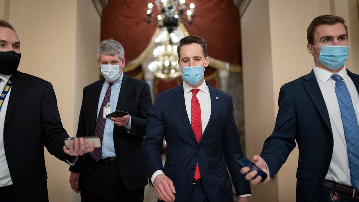After violent protesters loyal to President Donald Trump storm the U.S. Capitol on Wednesday, Jan. 6, Sen. Josh Hawley, R-Mo., walks to the House chamber to challenge the results of the presidential election in Pennsylvania. (AP Photo/J. Scott Applewhite)