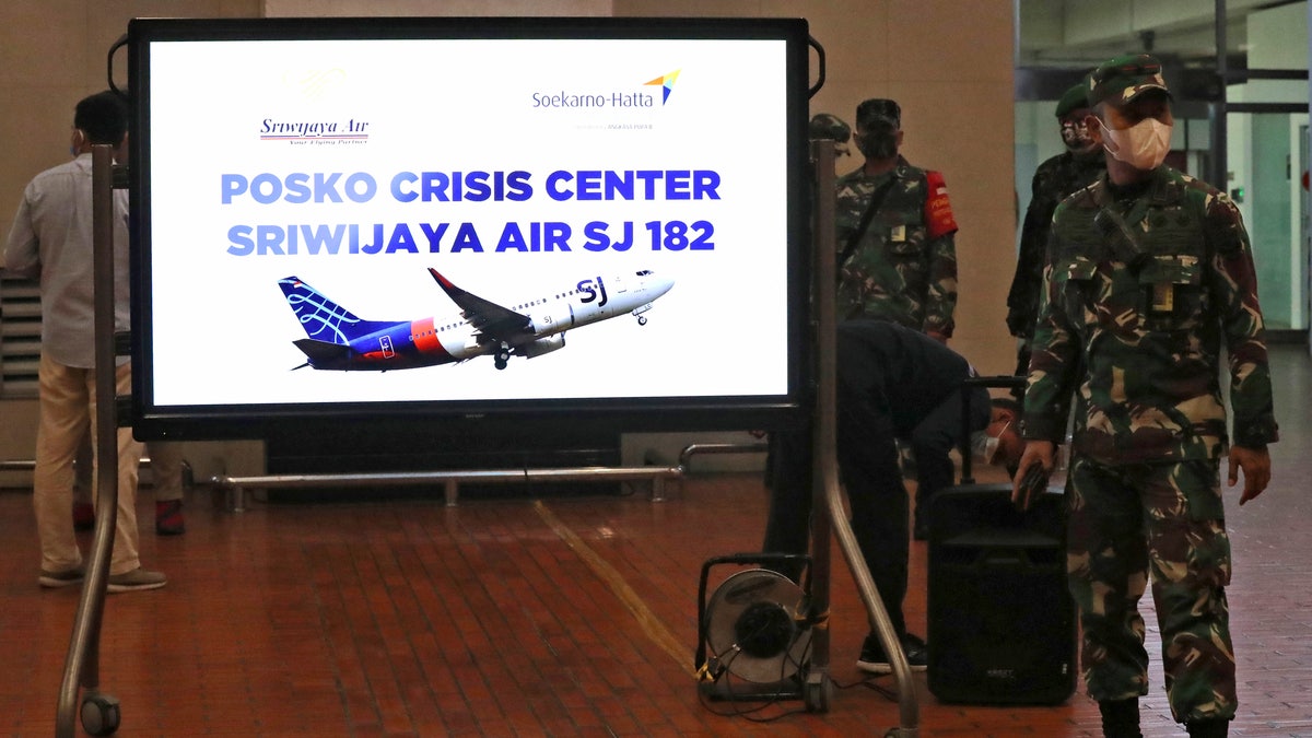 Indonesian soldiers stand near a crisis center set up following a report that a Sriwijaya Air passenger jet has lost contact with air traffic controllers after takeoff. (AP Photo/Tatan Syuflana)