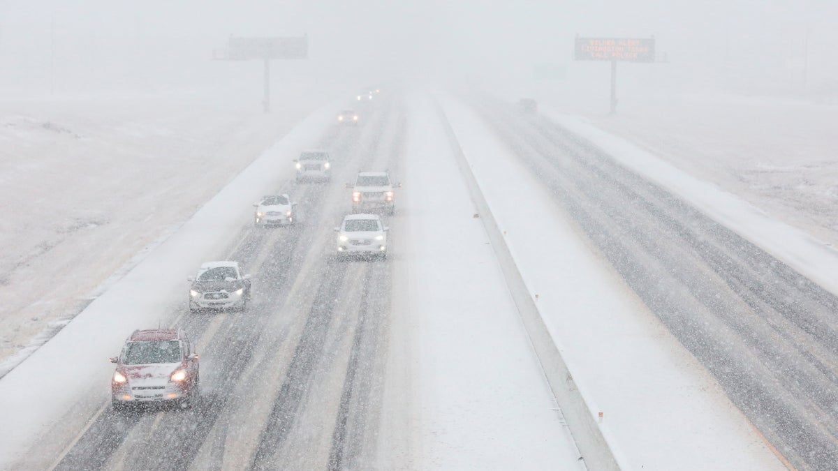 Vehicles driving in the snow on the southbound of Highway 6 Sunday, Jan. 10, 2021, in College Station, Texas. (Yi-Chin Lee/Houston Chronicle via AP)