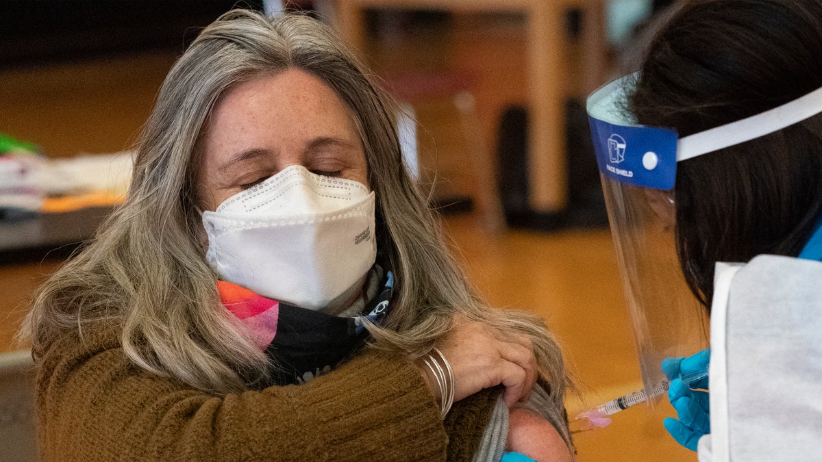 Teacher Lisa Egan is vaccinated with the Moderna coronavirus vaccine at a clinic organized by New York City's Department of Health, Monday, Jan. 11, 2021. (AP Photo/Mark Lennihan)