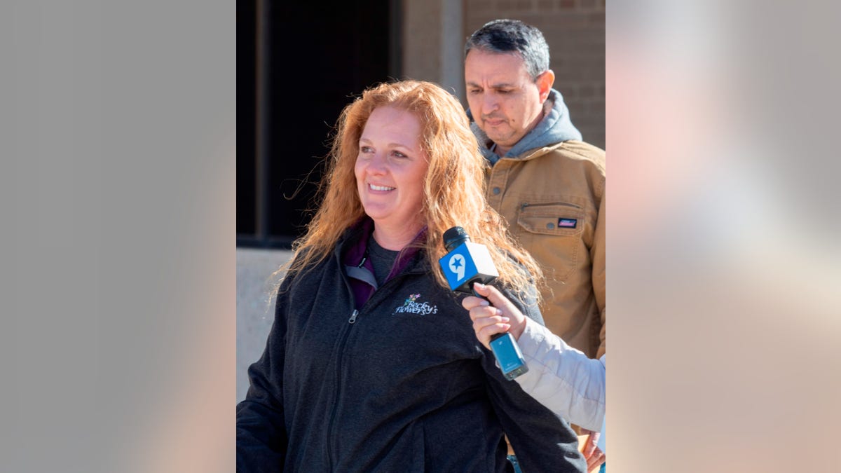 Jenny Cudd, front, a flower shop owner and former Midland mayoral candidate, and Eliel Rosa leave the federal courthouse in Midland, Texas, Wednesday, Jan. 13, 2021. (Tim Fischer/Reporter-Telegram via AP)