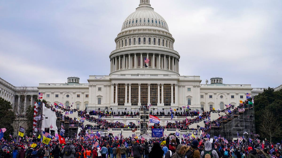 This file photo from Wednesday Jan. 6, 2021, shows Trump supporters swarming the Capitol, as Congress prepares to affirm then-President-elect Joe Biden's victory. (AP Photo/John Minchillo, File)