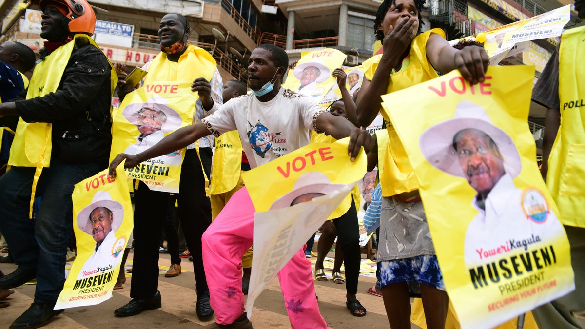 Supporters of Ugandan President Yoweri Kaguta Museveni celebrate, in Kampala, Uganda, on Saturday, Jan. 16, 2021, after their candidate was declared the winner of the presidential election. (AP Photo/Nicholas Bamulanzeki)