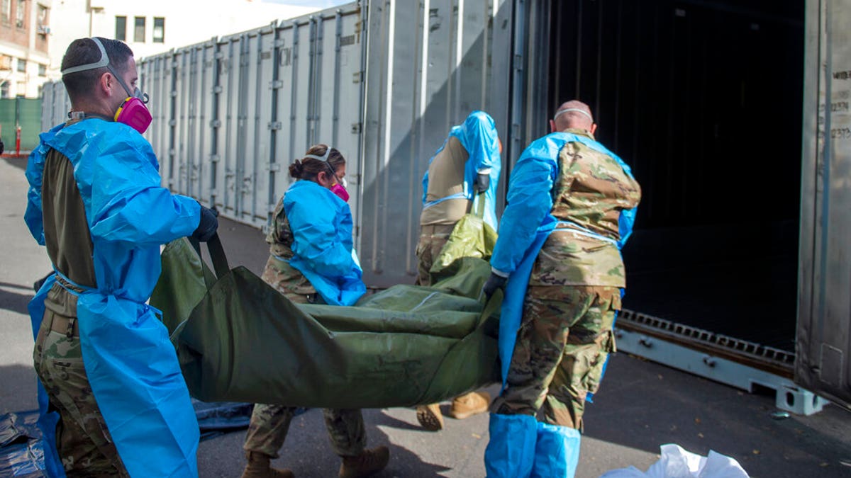 The LA County Dept. of Medical Examiner-Coroner shows National Guard members assisting with processing COVID-19 deaths and placing them into temporary storage at LA County Medical Examiner-Coroner Office in Los Angeles in Los Angeles.  