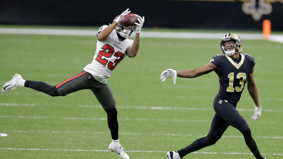 Tampa Bay Buccaneers cornerback Sean Murphy-Bunting (23) intercepts a pass intended for New Orleans Saints wide receiver Michael Thomas (13) during the first half of an NFL divisional round playoff football game, Sunday, Jan. 17, 2021, in New Orleans. (AP Photo/Brett Duke)