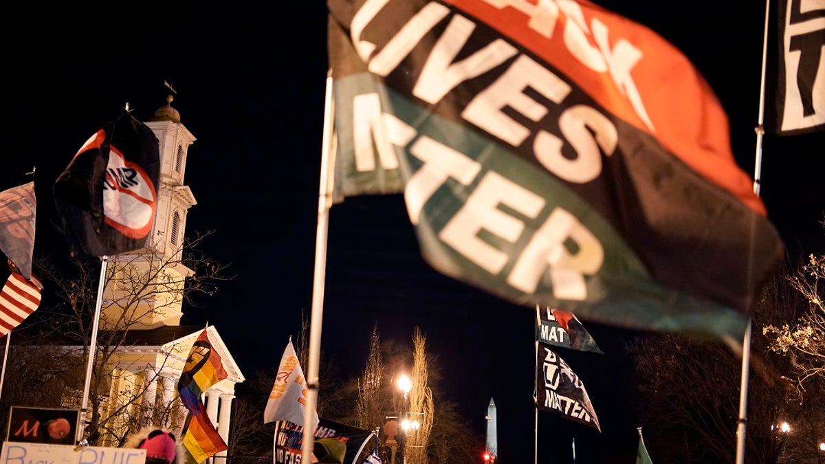 Protesters wave flags in the area known as Black Lives Matter plaza near the White House on Jan. 17. A Norwegian lawmaker has nominated the movement for the 2021 Nobel Peace Prize. (AP Photo/Wong Maye-E)