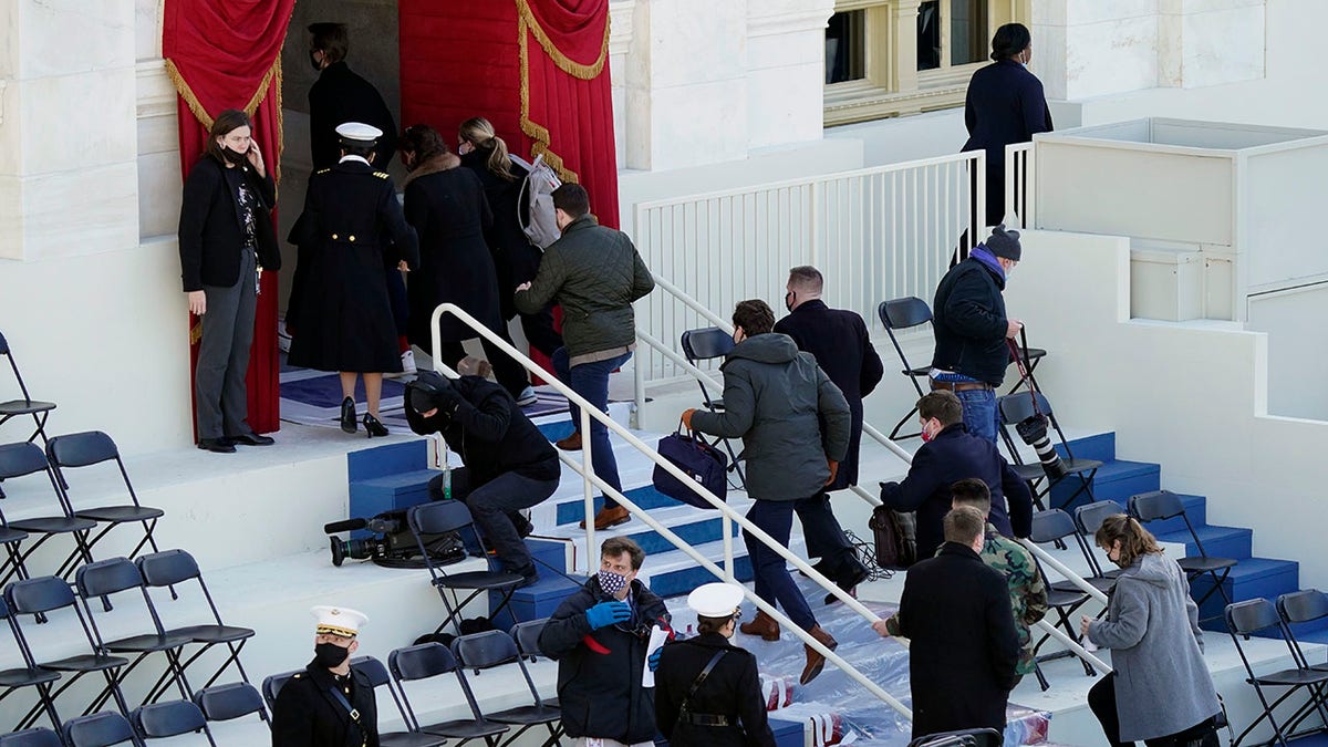 People evacuate from the West Front of the U.S. Capitol during a rehearsal the 59th Presidential Inauguration at the U.S. Capitol in Washington, Monday, Jan. 18, 2021. (AP Photo/Carolyn Kaster)