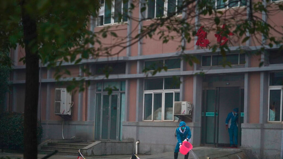 FILE: Hospital staff wash the emergency entrance of Wuhan Medical Treatment Center, where some infected with a new virus are being treated, in Wuhan, China.