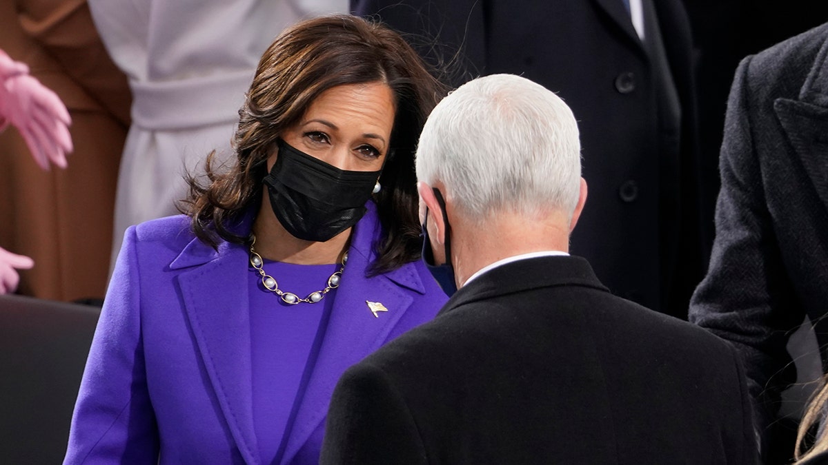 Vice President-elect Kamala Harris talks with Vice President Mike Pence during the 59th Presidential Inauguration at the U.S. Capitol in Washington, Wednesday, Jan. 20, 2021. (AP Photo/Andrew Harnik)