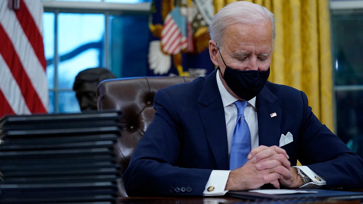 President Biden pausing as he signed his first executive orders in the Oval Office of the White House on Wednesday.