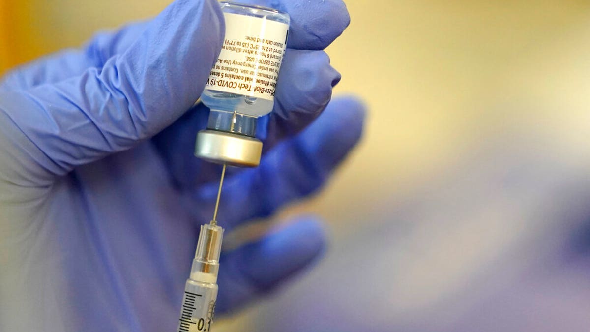 A pharmacist prepares a syringe of the Pfizer-BioNTech COVID-19 vaccine Friday, Jan. 8, 2021, at Queen Anne Healthcare, a skilled nursing and rehabilitation facility in Seattle. Pfizer has committed to supply up to 40 million doses of its COVID-19 vaccine this year to a World Health Organization-backed effort to get affordable vaccines to 92 poor and middle-income countries. The deal announced Friday, Jan. 22 will supply the shots to the program known as COVAX.