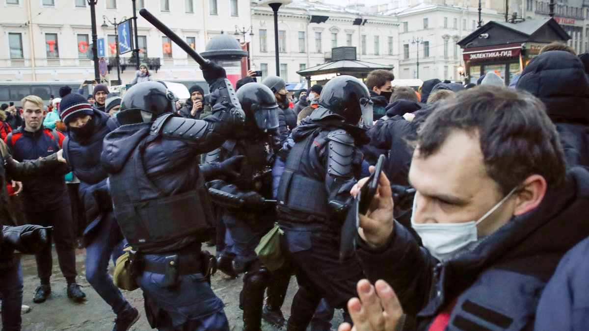 Police clash with demonstraters during a protest against the jailing of opposition leader Alexei Navalny in People gather in St.Petersburg, Russia, Saturday, Jan. 23, 2021. Russian police are arresting protesters demanding the release of top Russian opposition leader Alexei Navalny at demonstrations in the country's east and larger unsanctioned rallies are expected later Saturday in Moscow and other major cities. (AP Photo/Dmitri Lovetsky)