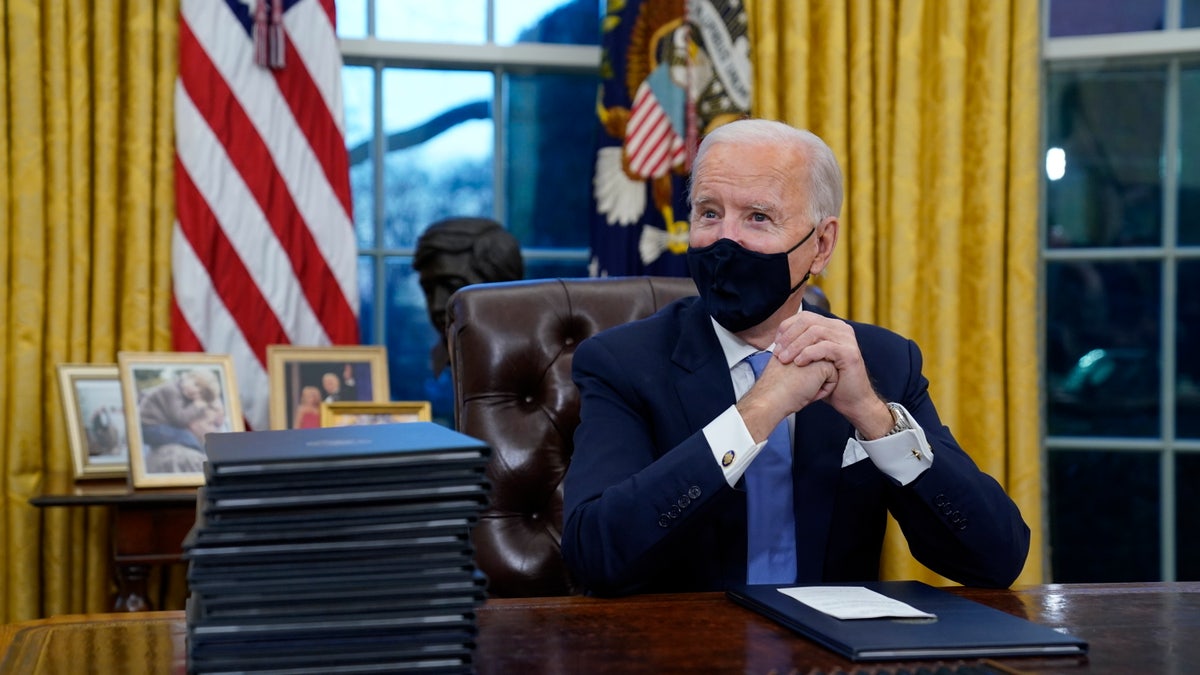 FILE - In this Jan. 20, 2021, file photo President Joe Biden waits to sign his first executive order in the Oval Office of the White House in Washington. As one of his first acts, Biden offered a sweeping immigration overhaul that would provide a path to U.S. citizenship for the estimated 11 million people who are in the United States illegally. It would also codify provisions wiping out some of President Donald Trump's signature hard-line policies, including trying to end existing, protected legal status for many immigrants brought to the U.S. as children and crackdowns on asylum rules. (AP Photo/Evan Vucci, File)