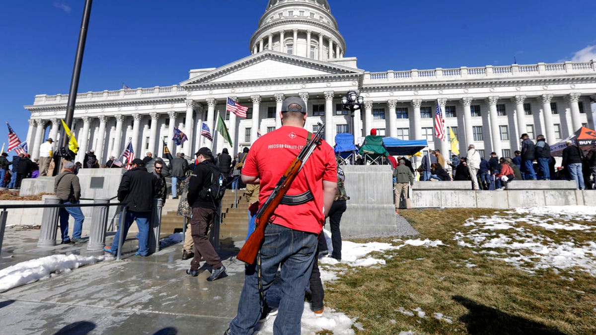 FILE: A man carries his weapon during a second amendment gun rally at Utah State Capitol on Feb. 8, 2020, in Salt Lake City.